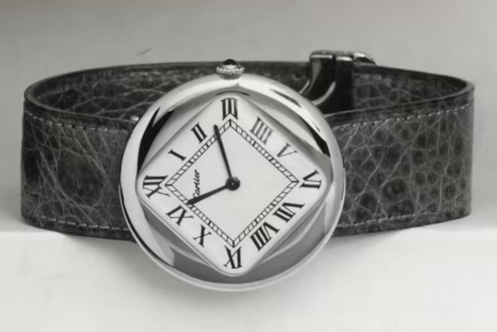 a black and white historical photo of the cartier pebble watch

